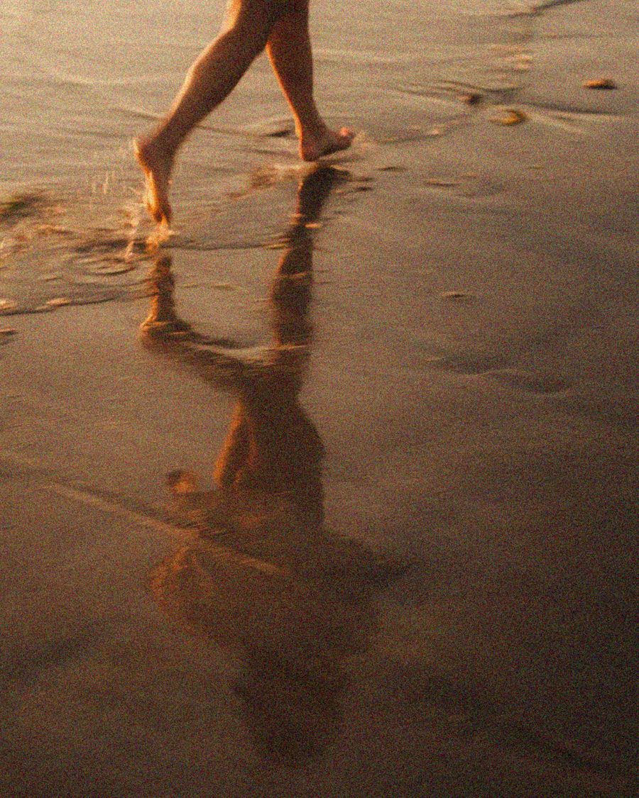 Walking along the shoreline at golden hour
